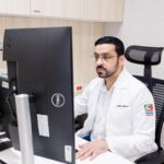 Dr. Nasir Mujeed, a specialist in neuromodulation and stem cell treatment, focused on his computer screen in his office at Verita Neuro.