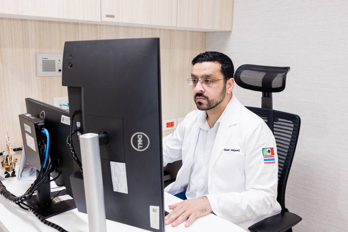 Dr. Nasir Mujeed, a specialist in neuromodulation and stem cell treatment, focused on his computer screen in his office at Verita Neuro.